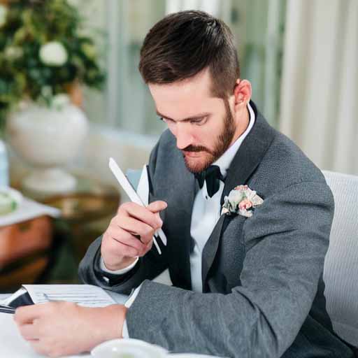 Groom sitting down planning his 1st anniversary at his wedding