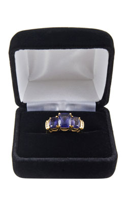 Iolite ring in a blue jewellery cushioned case indicating the type of gifts that can be purchased for the 21st year wedding anniversary