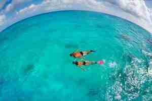 Couple swimming in a Turquoise Seascape