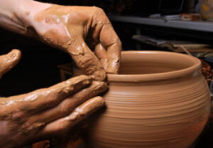 Potter shaping a clay pot