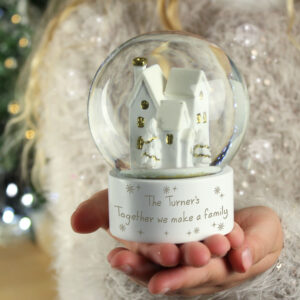 Personalised Golden Village Snow Globe a whimsical architectural design, resembling a house or church, adorned with golden windows that seem to shimmer.